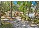 Charming home with lush landscaping, mature trees, and a welcoming front entrance at 626 Pearl Rd, Winter Springs, FL 32708
