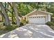 View of the two car garage with white door and driveway at 626 Pearl Rd, Winter Springs, FL 32708