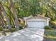 View of the two car garage with white door and driveway at 626 Pearl Rd, Winter Springs, FL 32708
