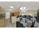 Open kitchen with bar seating, flowing into living and dining area at 626 Pearl Rd, Winter Springs, FL 32708