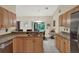 Bright kitchen with granite countertops and stainless steel appliances, open to backyard at 626 Pearl Rd, Winter Springs, FL 32708