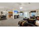 Open living room features a ceiling fan, television, bar seating and a dining area at 626 Pearl Rd, Winter Springs, FL 32708