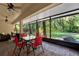 Enclosed patio with brick flooring, ceiling fans, outdoor seating, and firepit at 626 Pearl Rd, Winter Springs, FL 32708