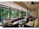 Enclosed patio offers comfortable outdoor seating and views of backyard trees at 626 Pearl Rd, Winter Springs, FL 32708