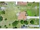 Aerial shot of a home with a spacious yard, pool, and outdoor seating area surrounded by a fence at 7065 Branch Court, St Cloud, FL 34771
