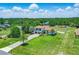 Beautiful aerial view of the property showcasing the lush landscaping and tile roof under blue skies at 7065 Branch Court, St Cloud, FL 34771