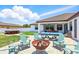 Backyard features a fire pit, ping pong table and hot tub offering outdoor entertainment at 7065 Branch Court, St Cloud, FL 34771