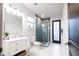 Bright bathroom with a white vanity, marble floors, and a glass-enclosed shower at 7065 Branch Court, St Cloud, FL 34771