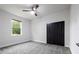 A neutral bedroom features plush carpet, a window, and a dark closet at 7065 Branch Court, St Cloud, FL 34771