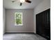 Bedroom featuring a window and closet doors, offering a view of the outdoors at 7065 Branch Court, St Cloud, FL 34771