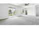 A room with a balcony overlooking the outdoors has neutral walls and carpeting at 7065 Branch Court, St Cloud, FL 34771