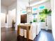 Bright dining room with modern light fixture, surrounded by large windows and dark wood flooring at 7065 Branch Court, St Cloud, FL 34771