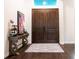 Elegant entryway showcases a stylish console table, complemented by a decorative rug and dark wood double doors at 7065 Branch Court, St Cloud, FL 34771