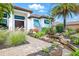 Charming home featuring a beautifully landscaped front yard with a stone walkway and a tranquil water feature at 7065 Branch Court, St Cloud, FL 34771