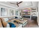 Inviting living room with a large gray sofa, modern fireplace, and stylish decor at 7065 Branch Court, St Cloud, FL 34771
