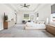 Serene main bedroom with soft carpet, a tray ceiling, and neutral tones throughout at 7065 Branch Court, St Cloud, FL 34771