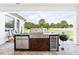 Outdoor kitchen with built-in grill and beverage cooler makes entertaining effortless at 7065 Branch Court, St Cloud, FL 34771