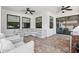 Covered outdoor patio with tile flooring, ceiling fans, and plenty of seating for relaxing or entertaining at 7065 Branch Court, St Cloud, FL 34771