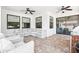 Covered patio with plush outdoor seating and ceiling fans for year-round comfort at 7065 Branch Court, St Cloud, FL 34771