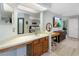 Bright bathroom with a makeup vanity, desk, and large mirror showing the bedroom area with a flat-screen TV and closet at 7858 Sugar View Ct # 7858, Orlando, FL 32819