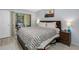 Comfortable bedroom with a Southwestern-style blanket, wood furniture, and sliding glass doors to the patio at 7858 Sugar View Ct # 7858, Orlando, FL 32819
