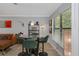 Cozy dining area boasts a glass table, green barstools, and stylish decor at 7858 Sugar View Ct # 7858, Orlando, FL 32819