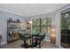 Bright dining area features a glass table, stylish bar stools, and views of the lush surrounding greenery at 7858 Sugar View Ct # 7858, Orlando, FL 32819