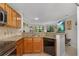 Kitchen featuring stainless steel appliances, granite countertops, breakfast bar, and light wood cabinets at 7858 Sugar View Ct # 7858, Orlando, FL 32819