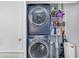 Closet with a stacked washer and dryer beside shelving with cleaning supplies and a vacuum cleaner at 7858 Sugar View Ct # 7858, Orlando, FL 32819
