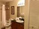 Bathroom with a shower, toilet, sink, and vanity with modern fixtures for everyday convenience at 8125 Resort Village Dr # 5808, Orlando, FL 32821