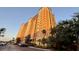 A multi-story building with balconies and parking space, surrounded by lush greenery at 8125 Resort Village Dr # 5808, Orlando, FL 32821