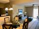 Cozy living room area with sofa, dining table, and chandelier, creating a comfortable atmosphere at 8125 Resort Village Dr # 5808, Orlando, FL 32821
