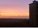 Scenic view of the horizon with a building situated on the side under an orange and purple sky at 8125 Resort Village Dr # 5808, Orlando, FL 32821