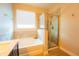Bright bathroom with a soaking tub, separate glass-enclosed shower, and elegant tile accents at 8137 Pond Apple Dr, Winter Garden, FL 34787