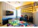 A gamer's themed bedroom with neon lighting, a gaming chair, and a large Fortnite mural at 8137 Pond Apple Dr, Winter Garden, FL 34787