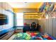 A gamer's themed bedroom with neon lighting, a gaming chair, and a large Fortnite mural at 8137 Pond Apple Dr, Winter Garden, FL 34787