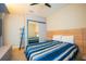Bedroom with a large bed, headboard with attached nightstands, and a mirrored sliding closet at 8137 Pond Apple Dr, Winter Garden, FL 34787