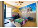 A gamer's themed bedroom with neon lighting, a gaming chair, and a large Fortnite mural at 8137 Pond Apple Dr, Winter Garden, FL 34787
