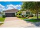 Charming single-story home with a well-maintained lawn, landscape, and paved driveway at 8137 Pond Apple Dr, Winter Garden, FL 34787