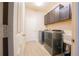 This laundry room features dark cabinets, a washer and dryer, utility sink, and tile floor at 8137 Pond Apple Dr, Winter Garden, FL 34787