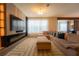 The spacious living room features a large sectional sofa, fireplace, modern lighting, and decorative carpeting at 8137 Pond Apple Dr, Winter Garden, FL 34787
