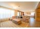 Bright, open living room showcasing a modern sofa, geometric rug, and seamless flow into the adjacent kitchen at 8137 Pond Apple Dr, Winter Garden, FL 34787