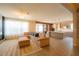 Bright open-concept living space flows into modern kitchen and dining area with tile flooring at 8137 Pond Apple Dr, Winter Garden, FL 34787