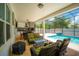 A cozy outdoor patio with screened-in pool, furniture, and outdoor kitchen at 8137 Pond Apple Dr, Winter Garden, FL 34787