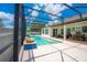 Outdoor entertaining poolside under a screened lanai with beautiful blue sky at 8137 Pond Apple Dr, Winter Garden, FL 34787