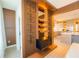 Unique storage unit in neutral tones with built-in shelving and creative lighting at 8137 Pond Apple Dr, Winter Garden, FL 34787