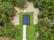 Overhead view of a new single-Gathering home with a pristine lawn surrounded by lush trees at 8258 Sw 136Th Ter, Dunnellon, FL 34432