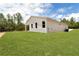A light beige single-story home with a covered porch and a large, well-maintained backyard at 8258 Sw 136Th Ter, Dunnellon, FL 34432