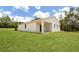 A bright white single-story home with a covered porch and a large, well-maintained backyard at 8258 Sw 136Th Ter, Dunnellon, FL 34432
