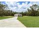 Charming single-story home with a well-manicured lawn and a long driveway leading to an attached garage at 8258 Sw 136Th Ter, Dunnellon, FL 34432